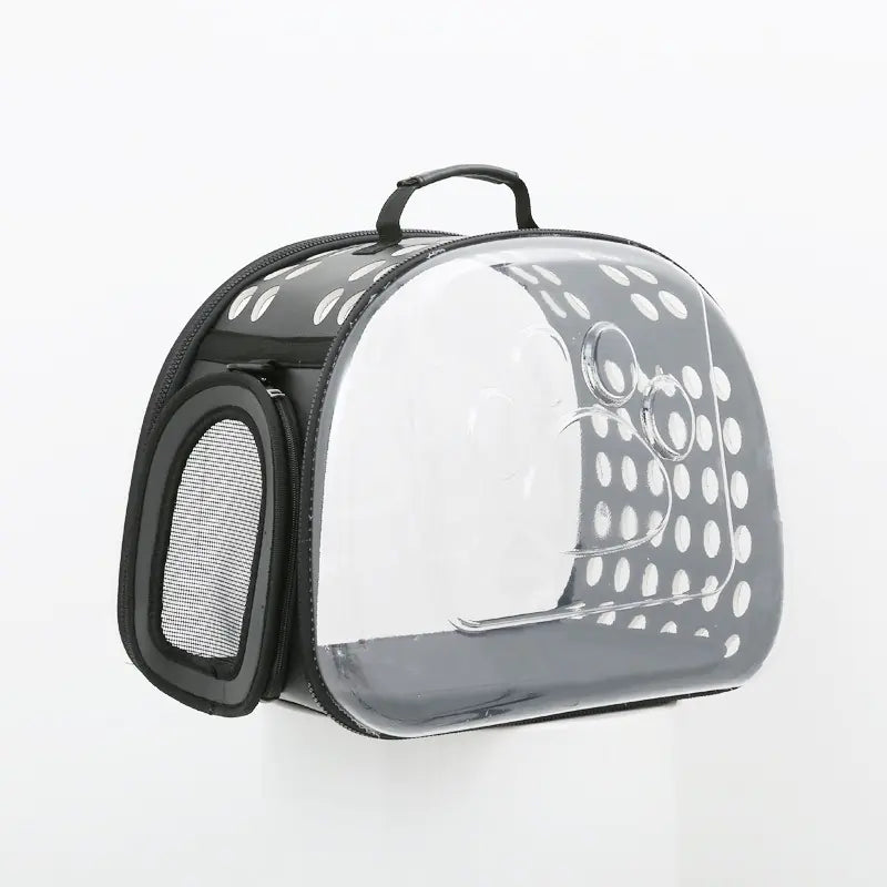 Transparent foldable pet carrier bag for cats and dogs with durable PVC construction and space capsule design.