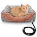 Heated cat bed indoor with thermostat, featuring an orange cat lying comfortably, showing warmth and safety features with a power cord.