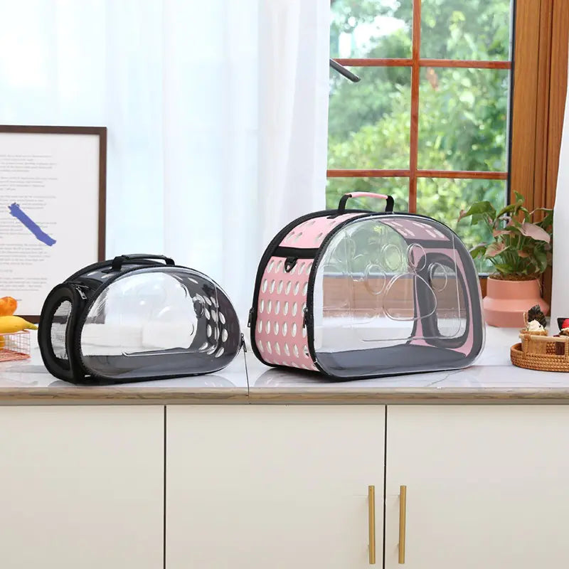 Foldable pet carrier bag with space capsule design for cats and dogs, shown on a table in a modern home setting.