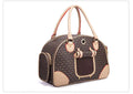 Stylish pet carrier bag for cats and dogs with luxurious design and dual handles, perfect for comfort and convenience.