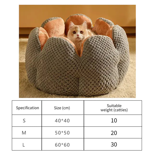 Cat sitting in a gray flower-shaped cat bed with size specifications chart for small, medium, and large sizes.
