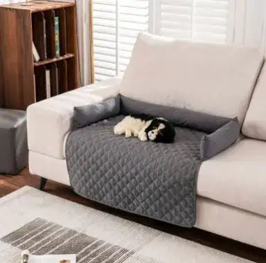 Waterproof pet sofa mat in gray with a small dog resting on it, protecting a white sofa in a cozy living room setting.