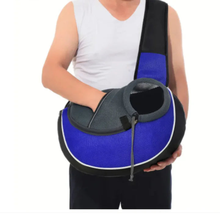 Man holding a blue pet travel carrier bag with breathable design for dogs and cats, enhancing comfort during travel.