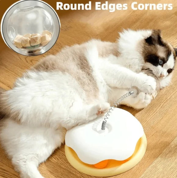 Cat playing with interactive cat feeder toy, slow feeder with treats