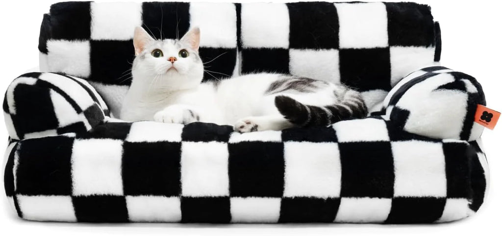 Cat lounging on a washable fluffy pet couch bed with a black and white checkered pattern.