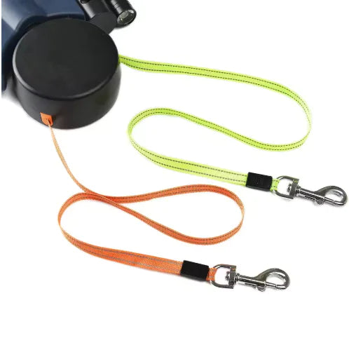 Automatic double dog leash with retractable dual leads for walking two dogs, featuring orange and green leashes with metal clips.