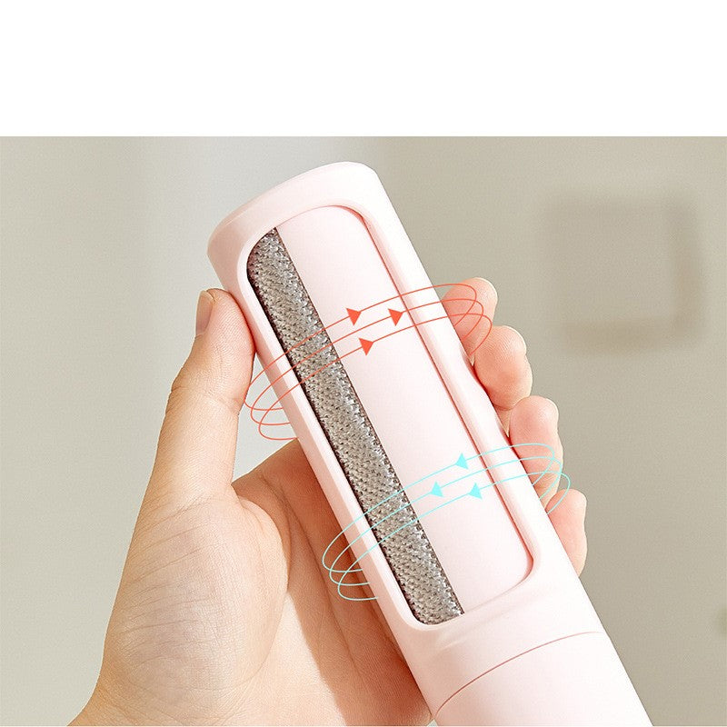 Hand holding a self-cleaning pet hair remover brush for cat and dog fur removal