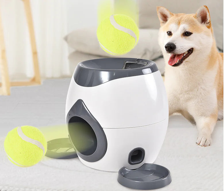 Interactive dog toy with ball feeder, tennis launcher and treat dispenser next to a dog ready to play. Perfect for active pets.
