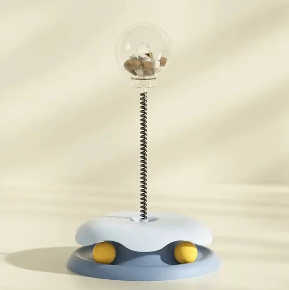 Interactive cat feeder toy with slow feeder food dispenser and spring mechanism for stimulating cat play and eating habits.