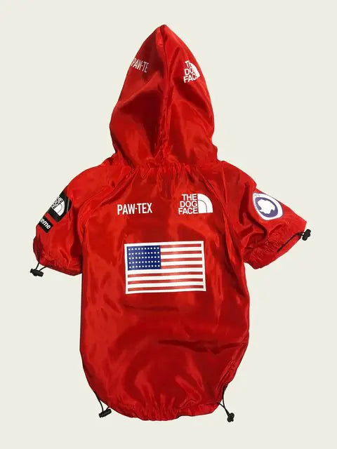 Red waterproof dog raincoat with USA flag design, featuring Paw-Tex label for stylish rainy day protection.