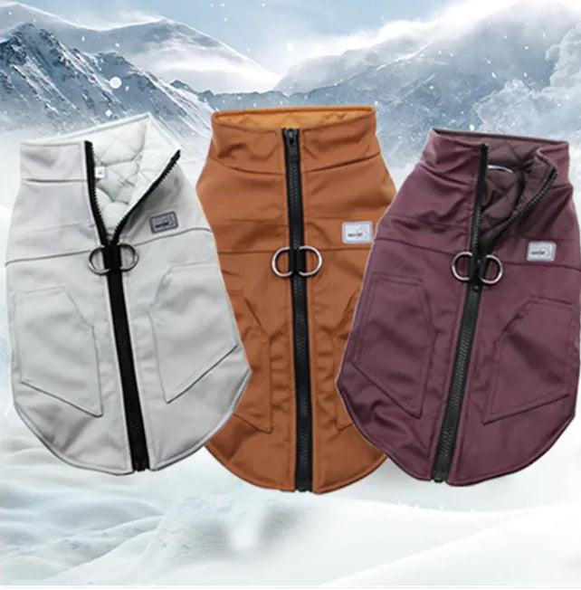Three leather winter pet vests in white, brown, and purple colors with a snowy mountain backdrop.