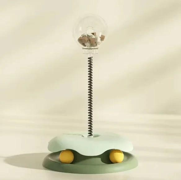 Interactive cat feeder toy - slow feeder food dispenser with spring and yellow balls, designed for stimulating and preventing overeating.