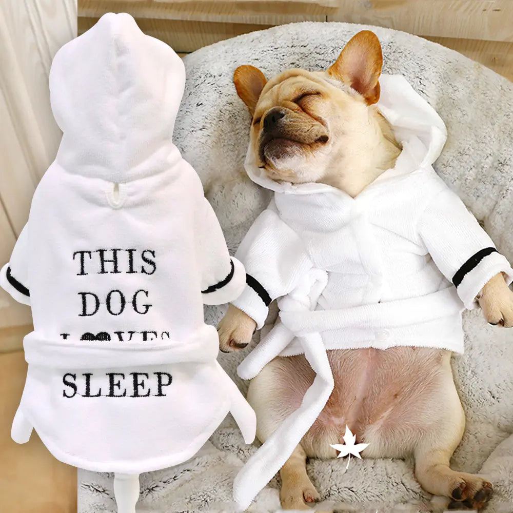 Dog in stylish dog clothes cotton bathrobe, relaxing and sleeping soundly, showcasing comfort and style.