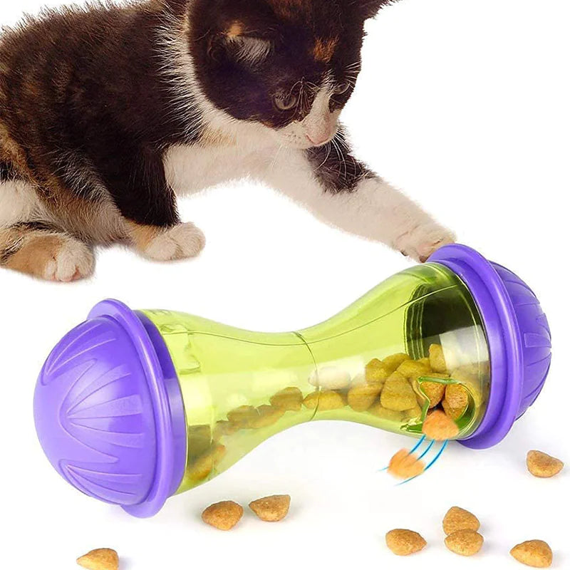 Cat playing with an interactive cat feeder toy tumbler and feeder ball, engaging its natural hunting instincts while dispensing food.
