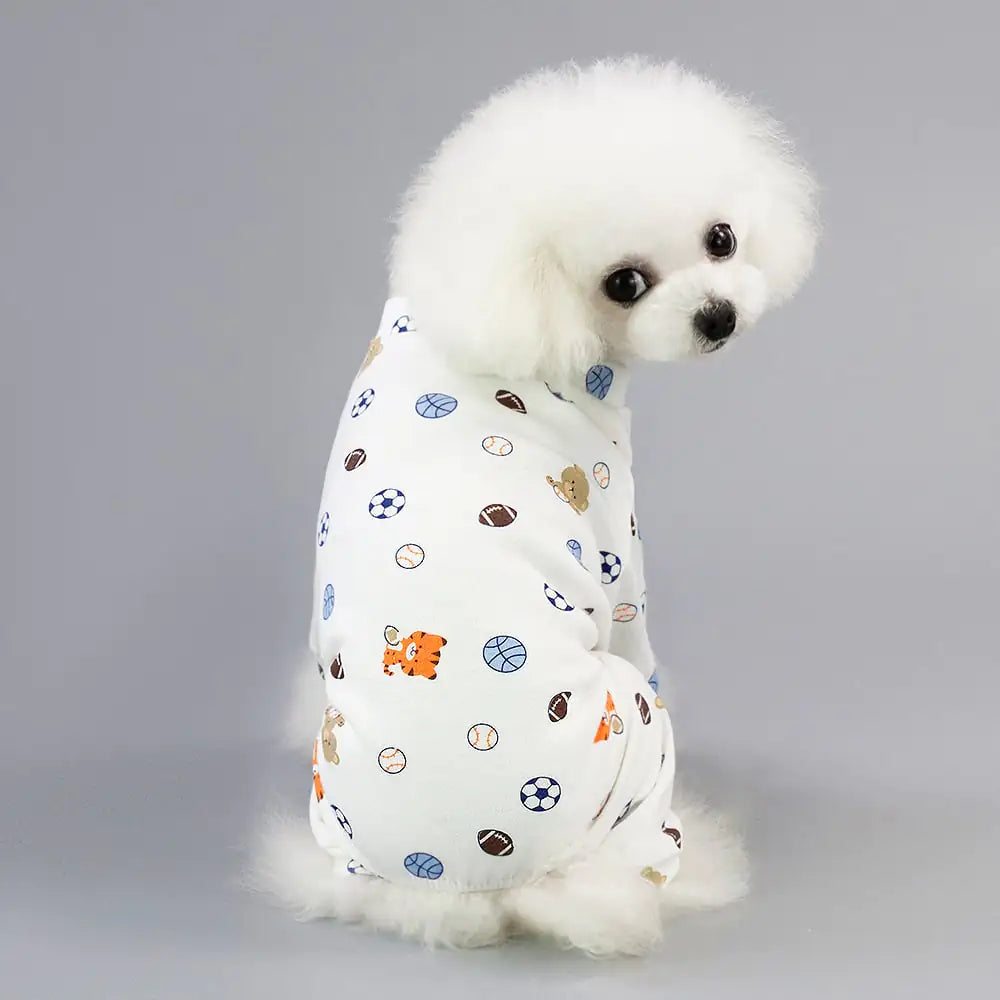 Fluffy dog wearing cartoon fruit dog pajamas with a four-legged design, featuring colorful patterns, made from soft cotton for pet comfort.