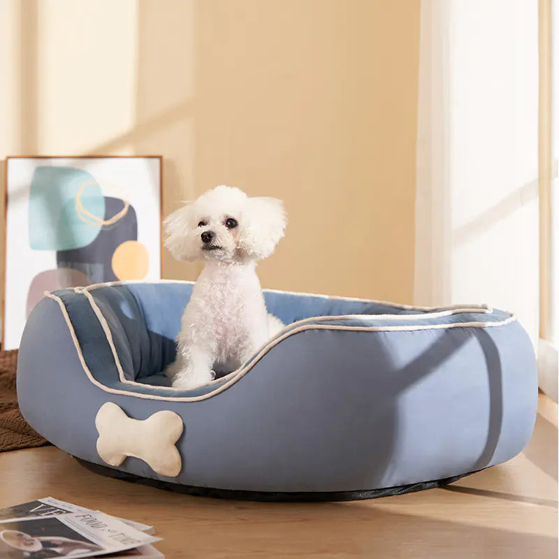 White dog sitting on a blue small pet sofa bed made of cotton linen, ideal for cats or small to medium dogs.