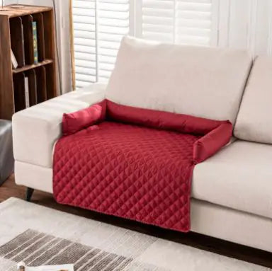 Red waterproof pet sofa mat on white sofa, protecting against spills and pet accidents, enhancing comfort and cleanliness.