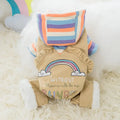 Small dog wearing a winter outfit with rainbow design, part of the small dog winter clothes collection for autumn season.