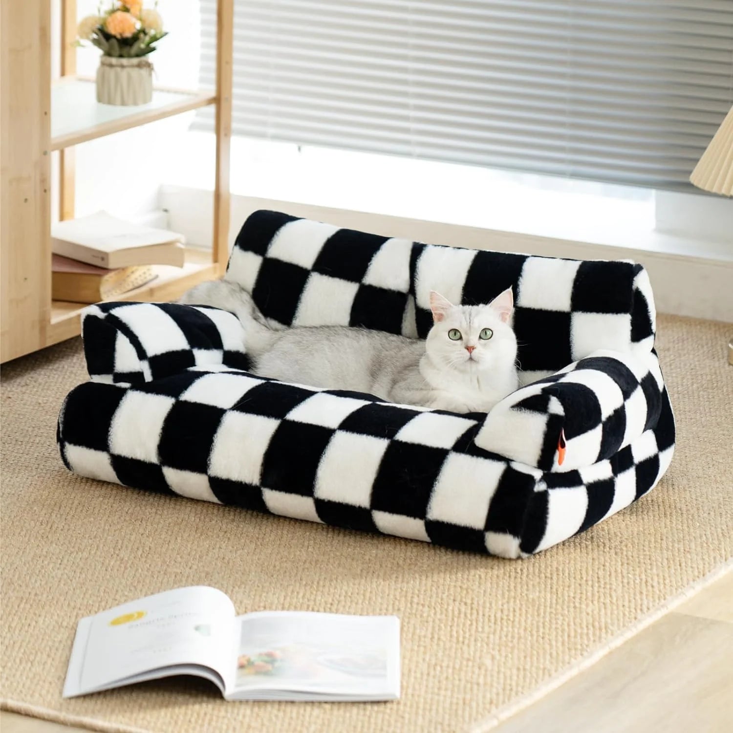 Cat lounging on a washable fluffy pet couch bed with black and white checkered design