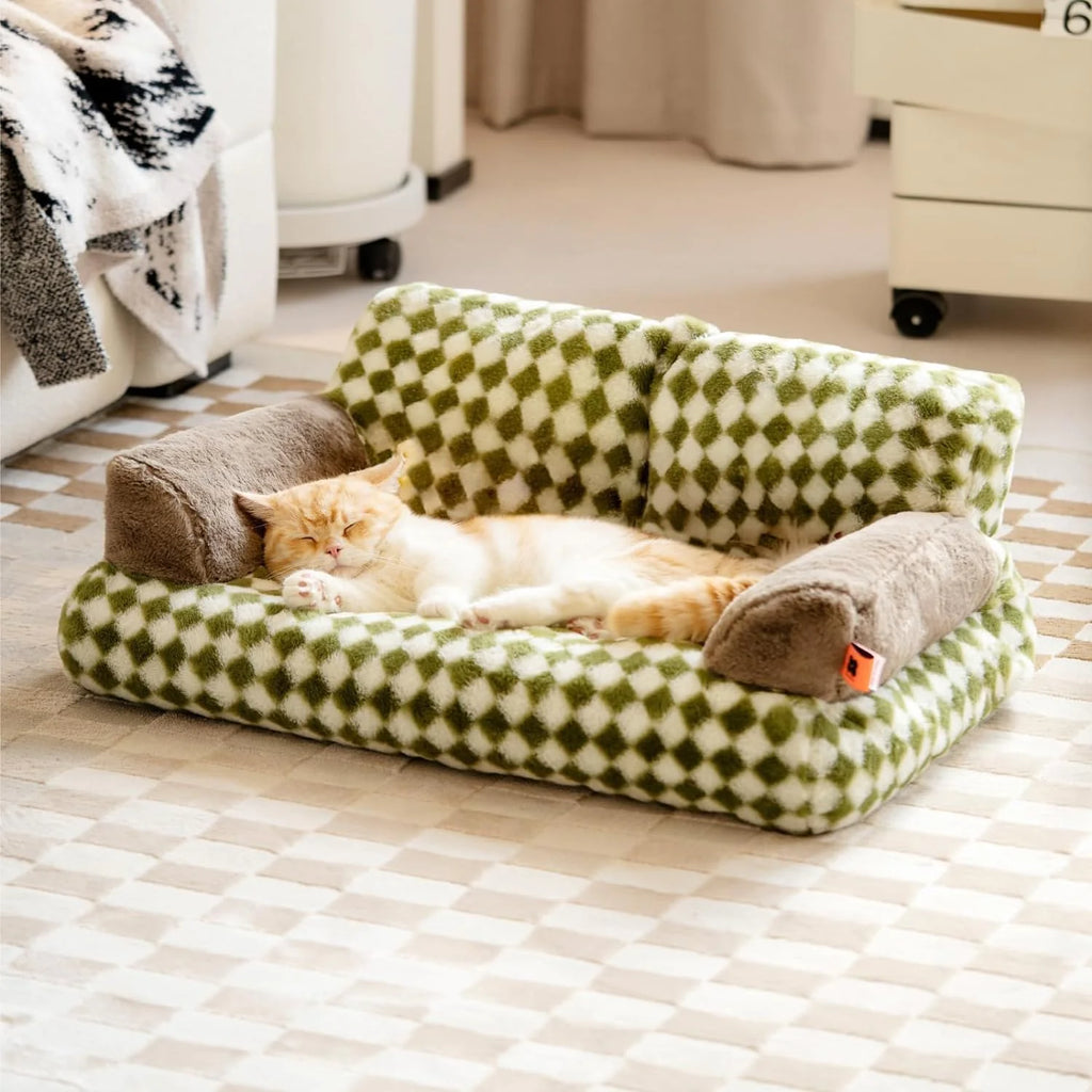 Cat sleeping on a green and white checkered washable fluffy pet couch bed with non-slip design in a cozy room setting.