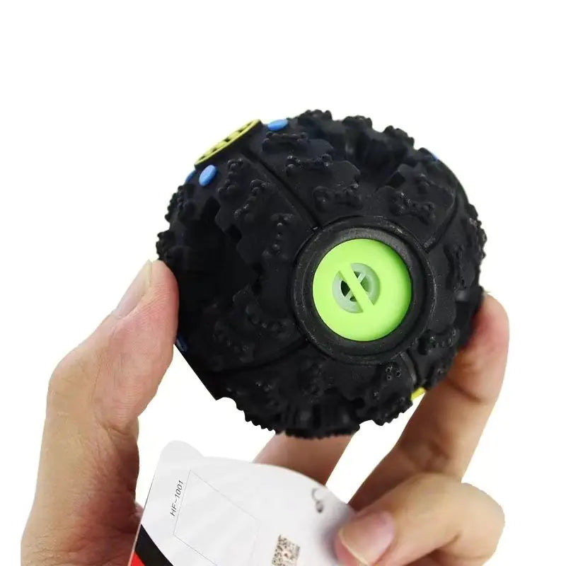 Person holding durable chew toys for dogs, a black sound ball designed for training and promoting healthy chewing habits.