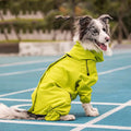 Large dog wearing a reflective waterproof dog coat in bright yellow, sitting on a blue track. Perfect for outdoor adventures.