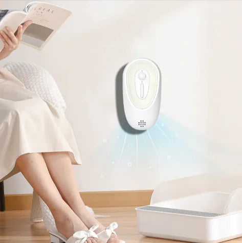 litter box odor eliminator mounted on wall near woman reading, neutralizing pet odors